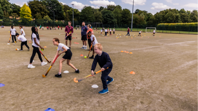 Children playing hockey at a school festival